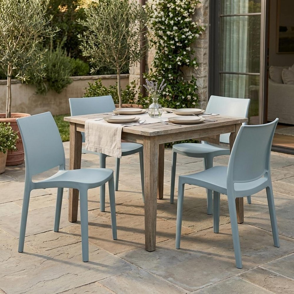 Set of Four Baby Blue Heavy Duty Plastic Outdoor Stacking Dining Chairs in a home interior