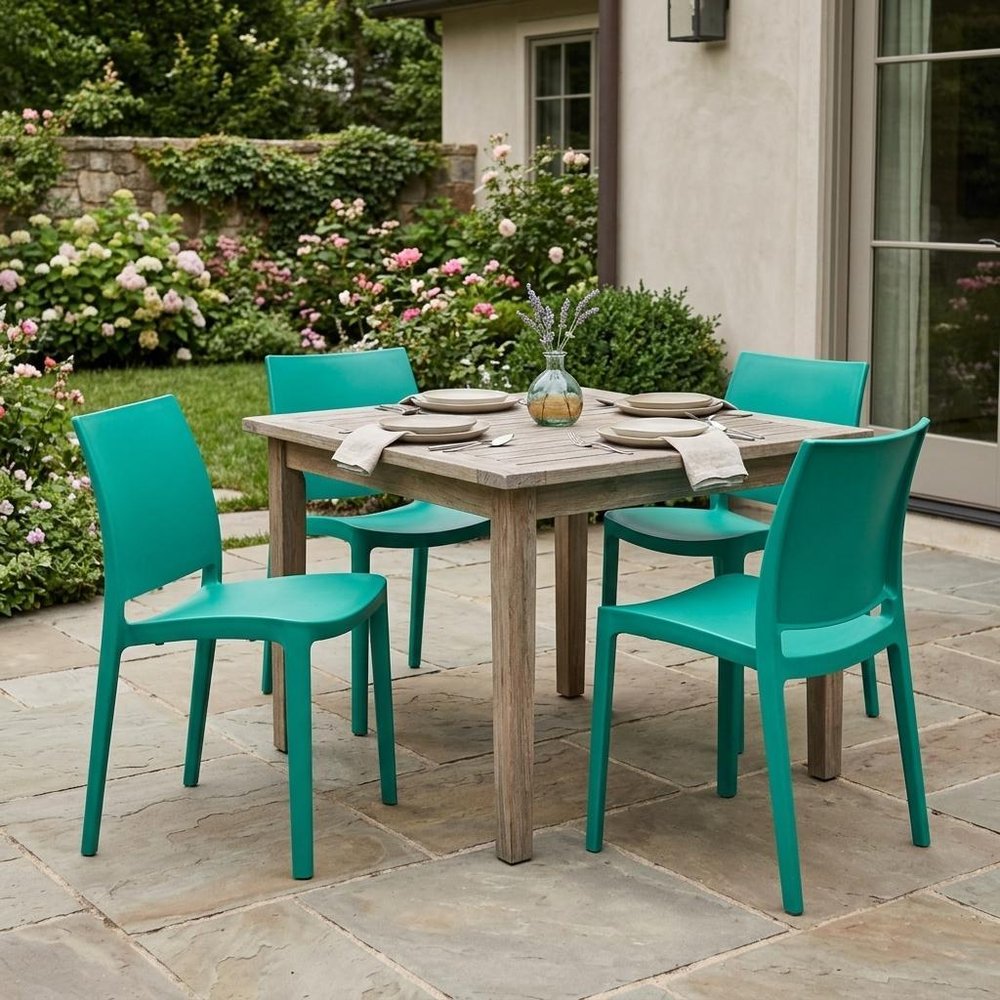 Set of Four Turquoise Heavy Duty Plastic Outdoor Stacking Dining Chairs in a home interior