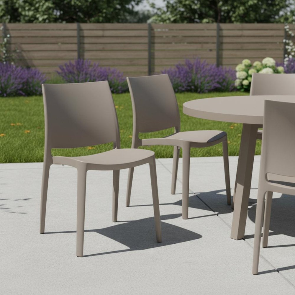 Set of Four Taupe Heavy Duty Plastic Outdoor Stacking Dining Chairs in a home interior