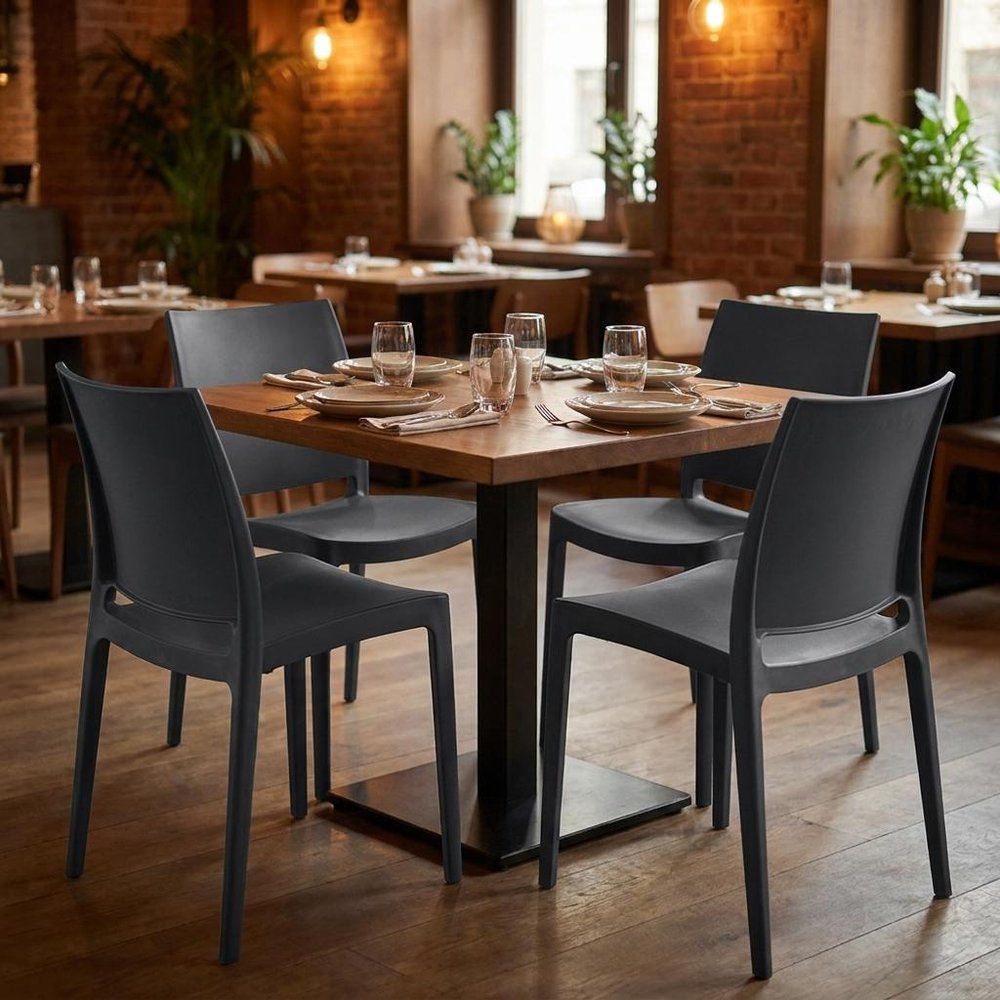 Set of Four Dark Gray Heavy Duty Plastic Outdoor Stacking Dining Chairs in a home interior