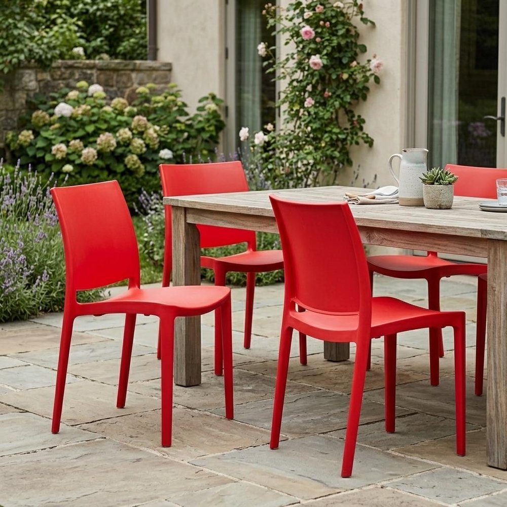 Set of Four Red Heavy Duty Plastic Outdoor Stacking Dining Chairs in a home interior