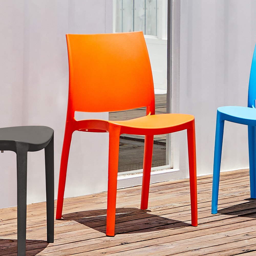 Set of Four Orange Heavy Duty Plastic Outdoor Stacking Dining Chairs in a home interior