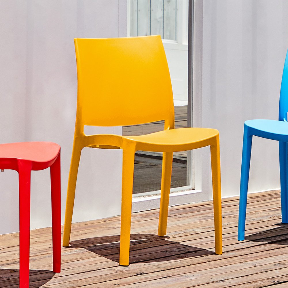 Set of Four Gold Heavy Duty Plastic Outdoor Stacking Dining Chairs in a home interior
