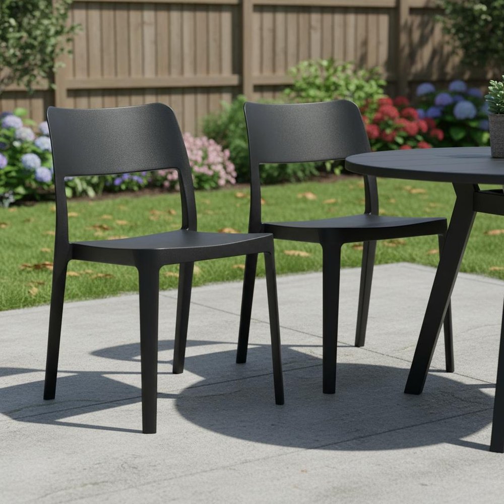 Set of Two Black Heavy Duty Plastic Outdoor Stacking Accent Chairs in a home interior