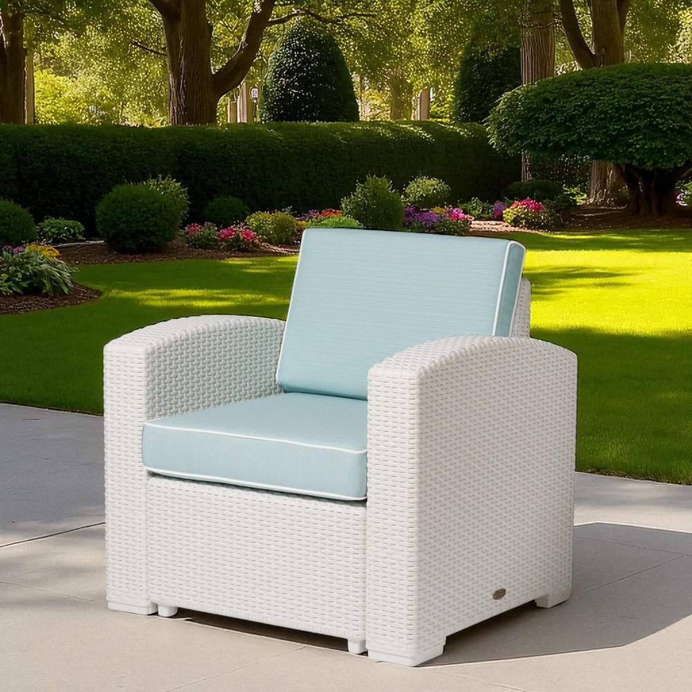 33" White Heavy Duty Plastic Outdoor Club Chair With Aqua Blue Cushion shown outdoors on a tiled patio with greenery.