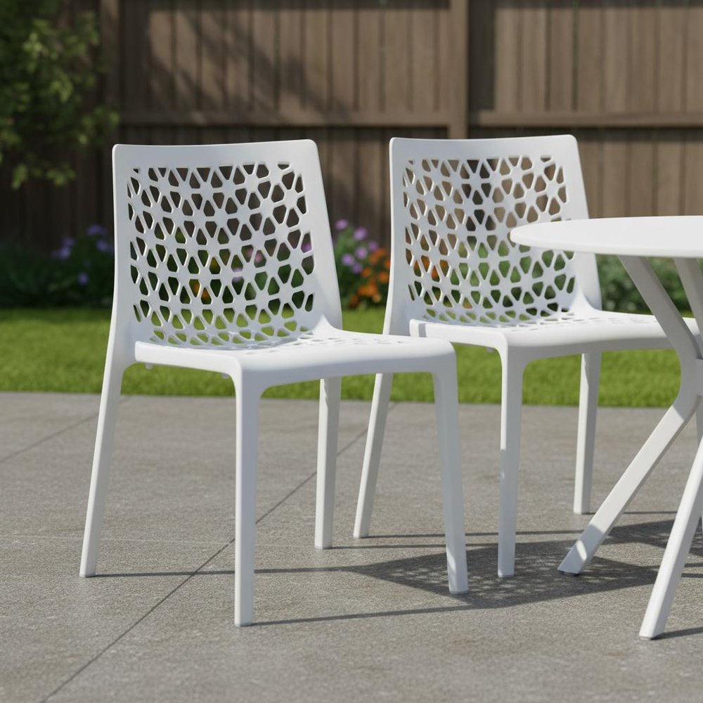 Set of Two White Heavy Duty Plastic Outdoor Stacking Dining Chairs in a home interior