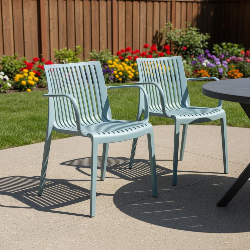 Set of Two Baby Blue Heavy Duty Plastic Outdoor Stacking Arm Chairs in a home interior