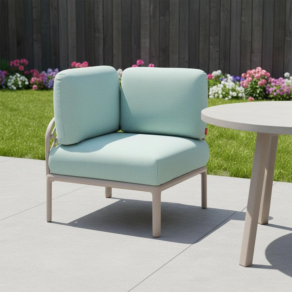 31" Sea Green Heavy Duty Plastic Outdoor Modular with Sea Green Cushion shown outdoors on a patio with greenery in gray plastic.