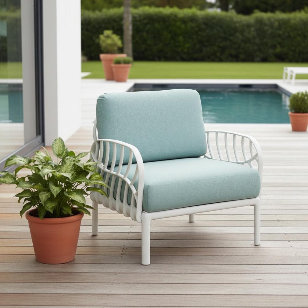 31" White Heavy Duty Plastic Outdoor Armchair With Sea Green Cushion shown outdoors on a patio.