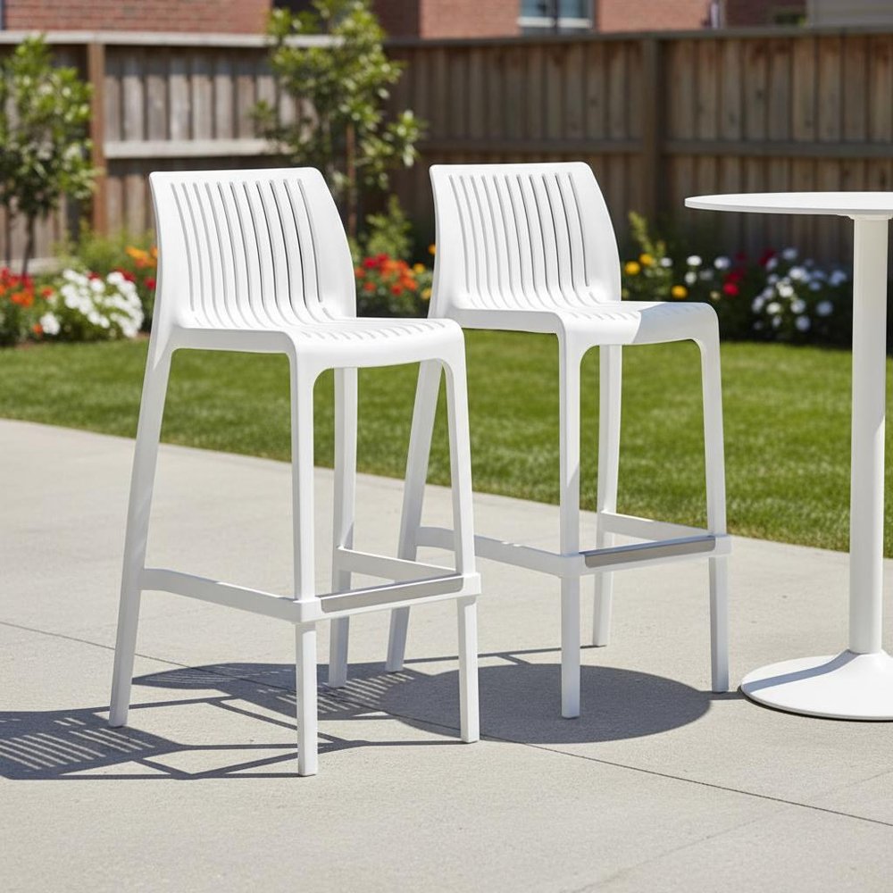 Set of Two 30" White Heavy Duty Plastic Low Back Outdoor Bar Height Chairs in a home interior