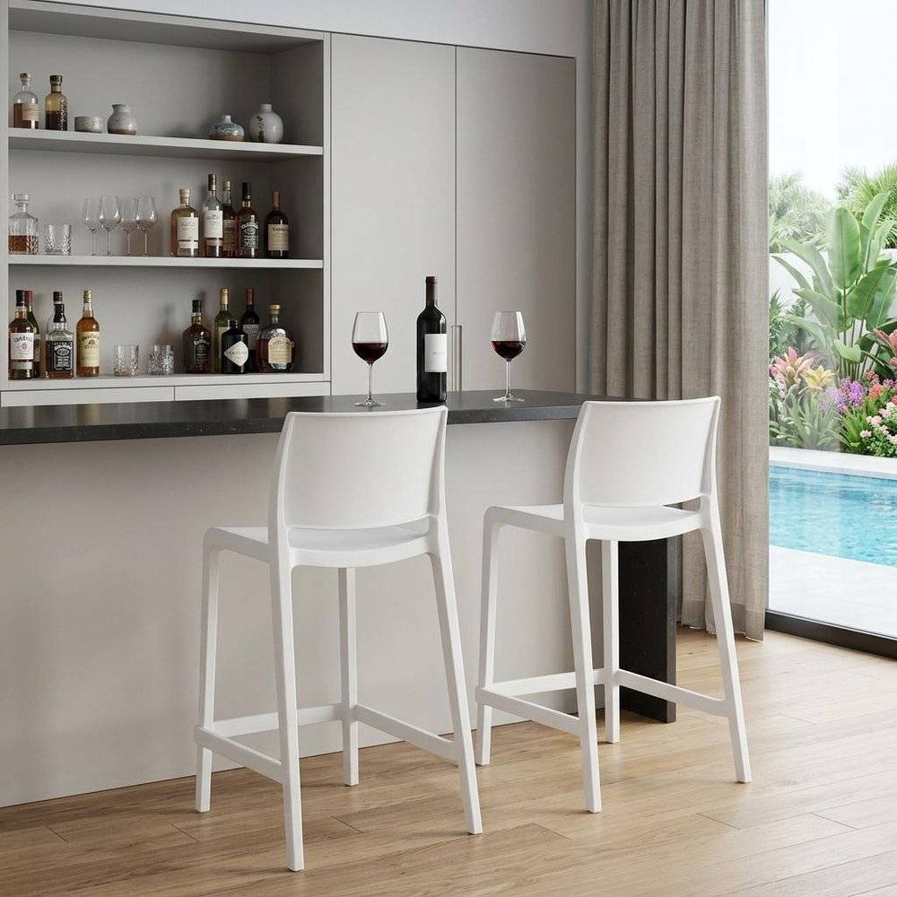 Set of Two 26" White Heavy Duty Plastic Low Back Outdoor Counter Height Bar Chairs in a home interior