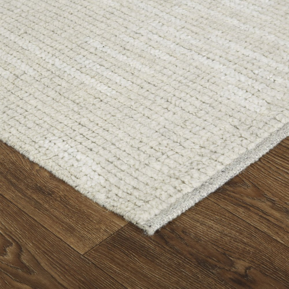 9' X 13' Tan and Ivory Wool Hand Knotted Area Rug in a home interior