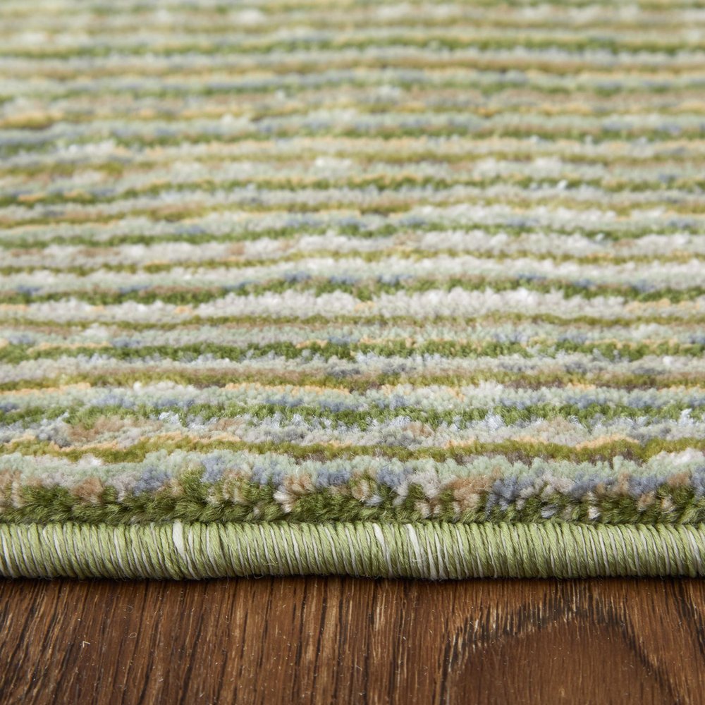 9' X 13' Tan and Green Power Loom Area Rug in a home interior