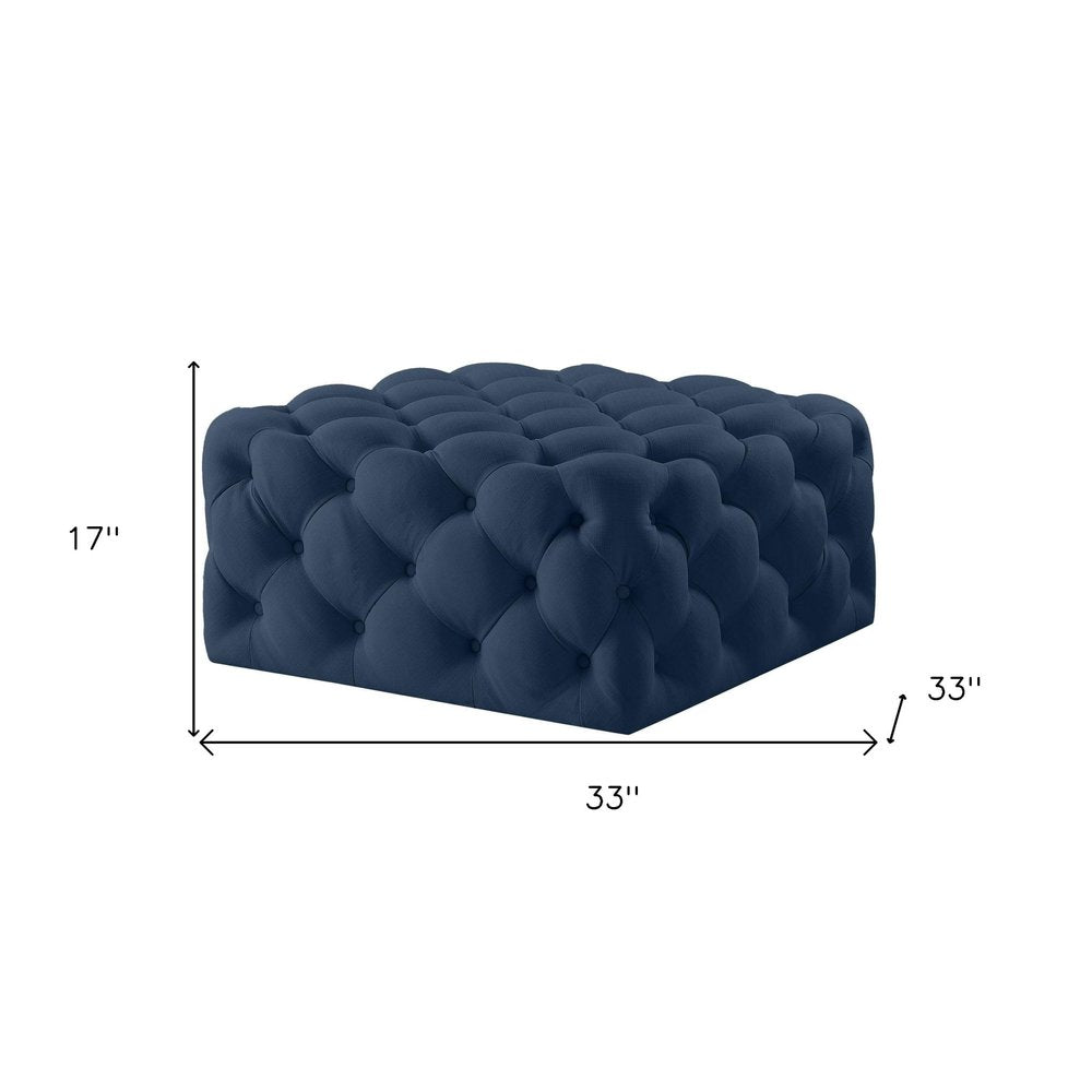33" Navy Blue Velvet Rolling Tufted Cocktail Ottoman. Ottoman isolated on a plain white background, showing a navy velvet surface.