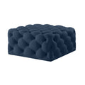 Navy blue tufted velvet ottoman on a white background.