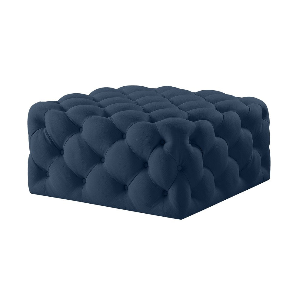 Navy blue tufted velvet ottoman on a white background.