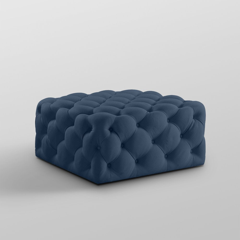 33" Navy Blue Velvet Rolling Tufted Cocktail Ottoman. Ottoman isolated on a plain white background, showing a navy velvet surface.