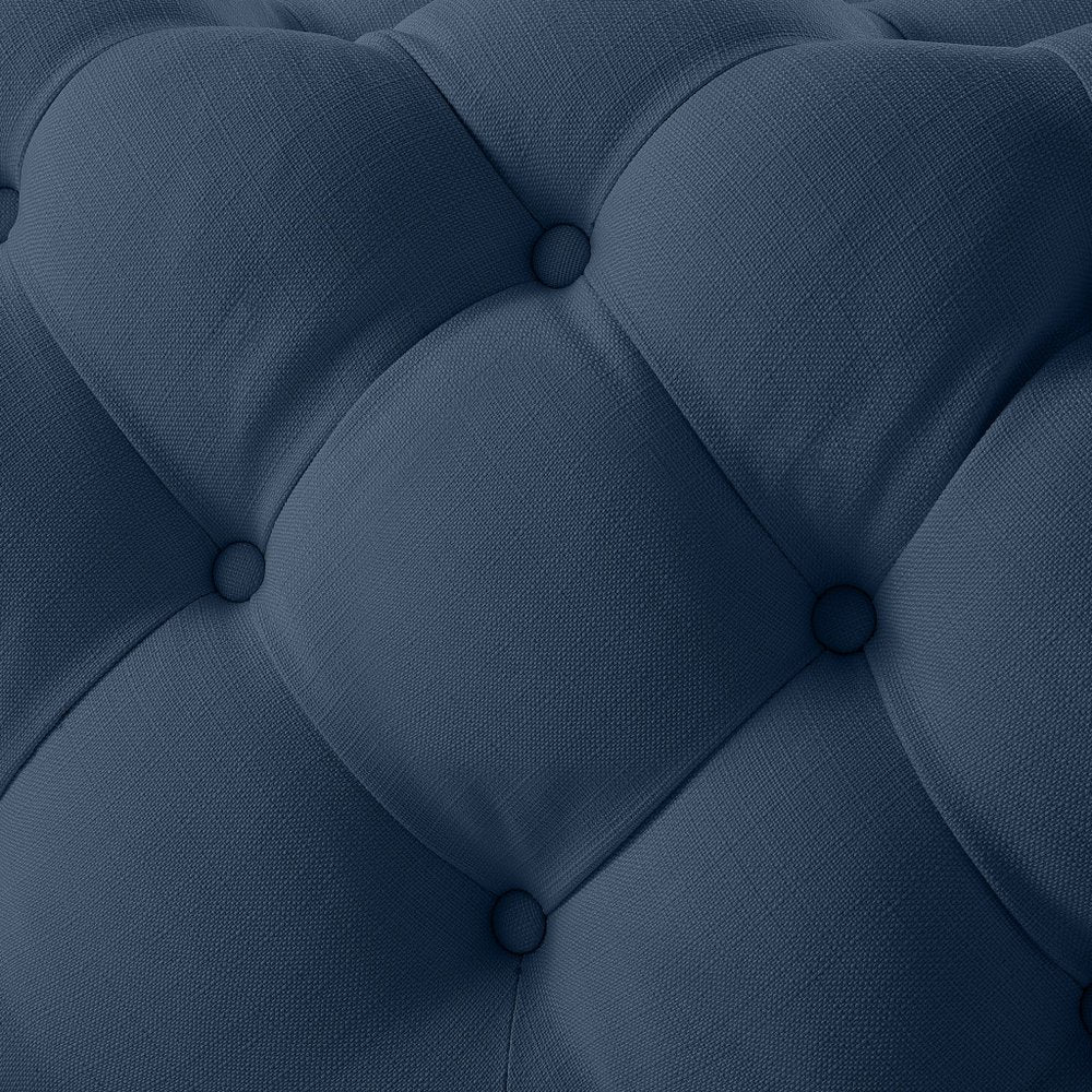 Close-up of 33" Navy Blue Velvet Rolling Tufted Cocktail Ottoman showing the navy velvet texture.