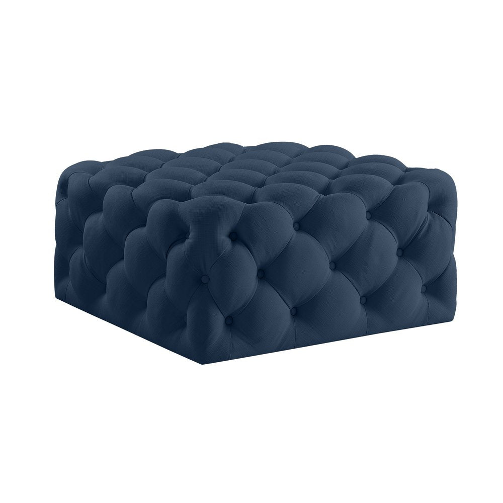33" Navy Blue Velvet Rolling Tufted Cocktail Ottoman. Ottoman isolated on a plain white background, showing a navy velvet surface.