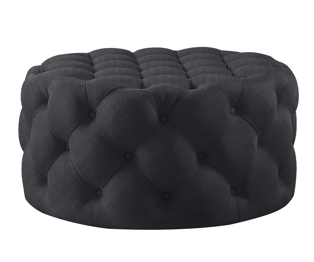 33" Black Linen Tufted Round Cocktail Ottoman. Ottoman isolated on a plain white background, in a black linen finish.