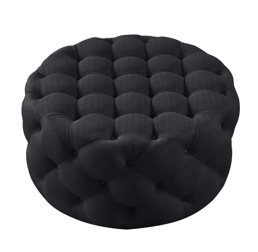 33" Black Linen Tufted Round Cocktail Ottoman. Ottoman isolated on a plain white background, finished in black linen.