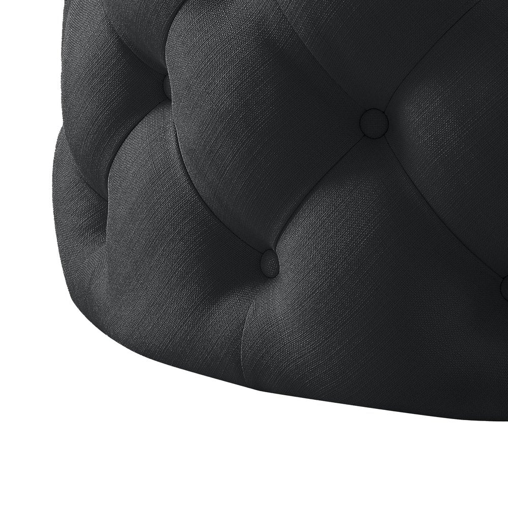 33" Black Linen Tufted Round Cocktail Ottoman. Ottoman isolated on a plain white background, showing a black linen surface.