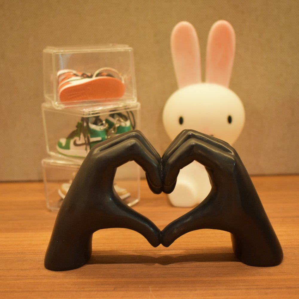 4" Black Resin Heart Hands Tabletop Sculpture. Sculpture in black resin.
