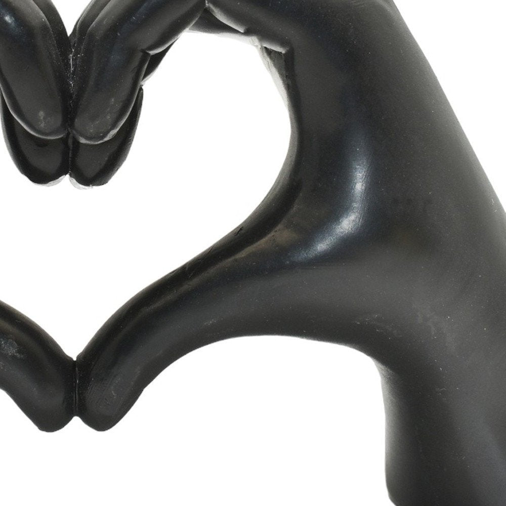 4" Black Resin Heart Hands Tabletop Sculpture. Sculpture in black resin.