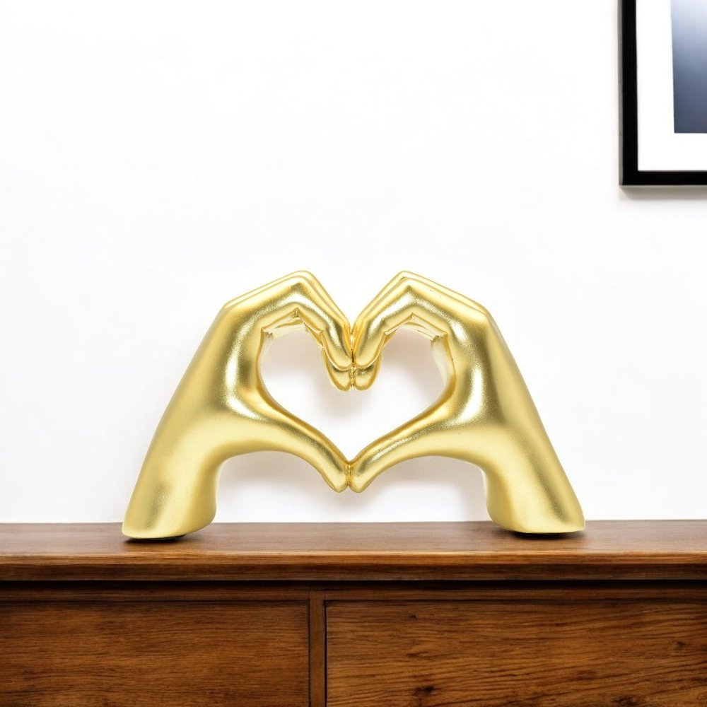 4" Gold Resin Heart Hands Tabletop Sculpture. Sculpture isolated on a plain white background, finished in gold resin.