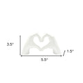 4" White Resin Heart Hands Tabletop Sculpture. Sculpture isolated on a plain white background, showing a white resin surface.