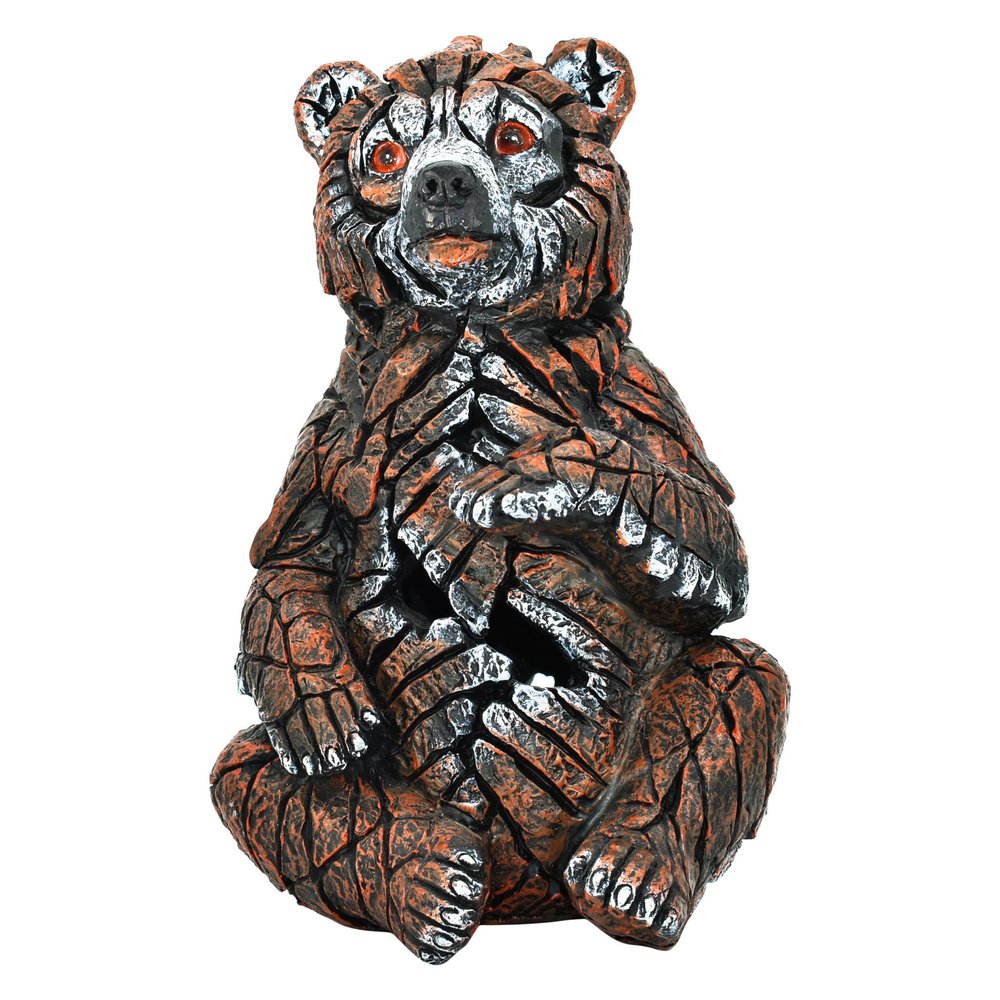 6" Brown White And Black Resin Bear Tabletop Sculpture. Sculpture isolated on a plain white background, showing a black resin surface.