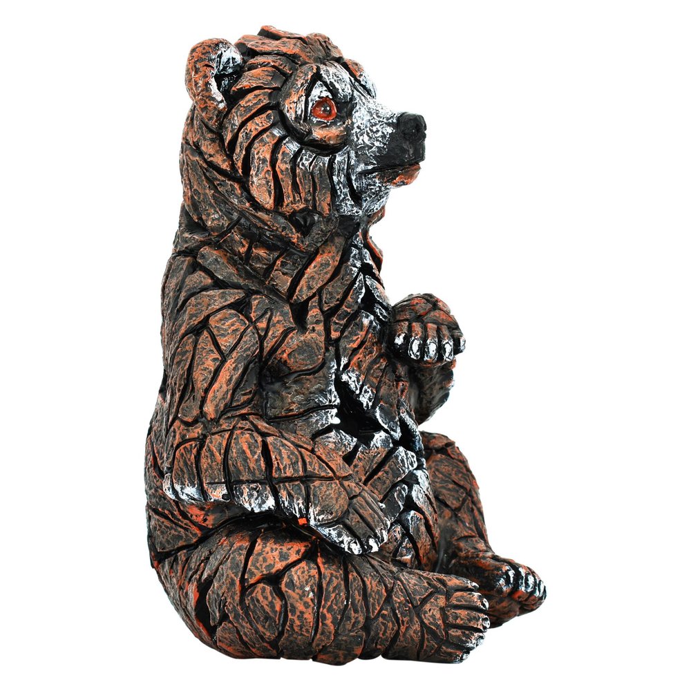 6" Brown White And Black Resin Bear Tabletop Sculpture. Sculpture isolated on a plain white background, in a black resin finish.