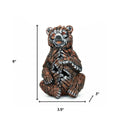 6" Brown White And Black Resin Bear Tabletop Sculpture. Sculpture isolated on a plain white background, showing a black resin surface.