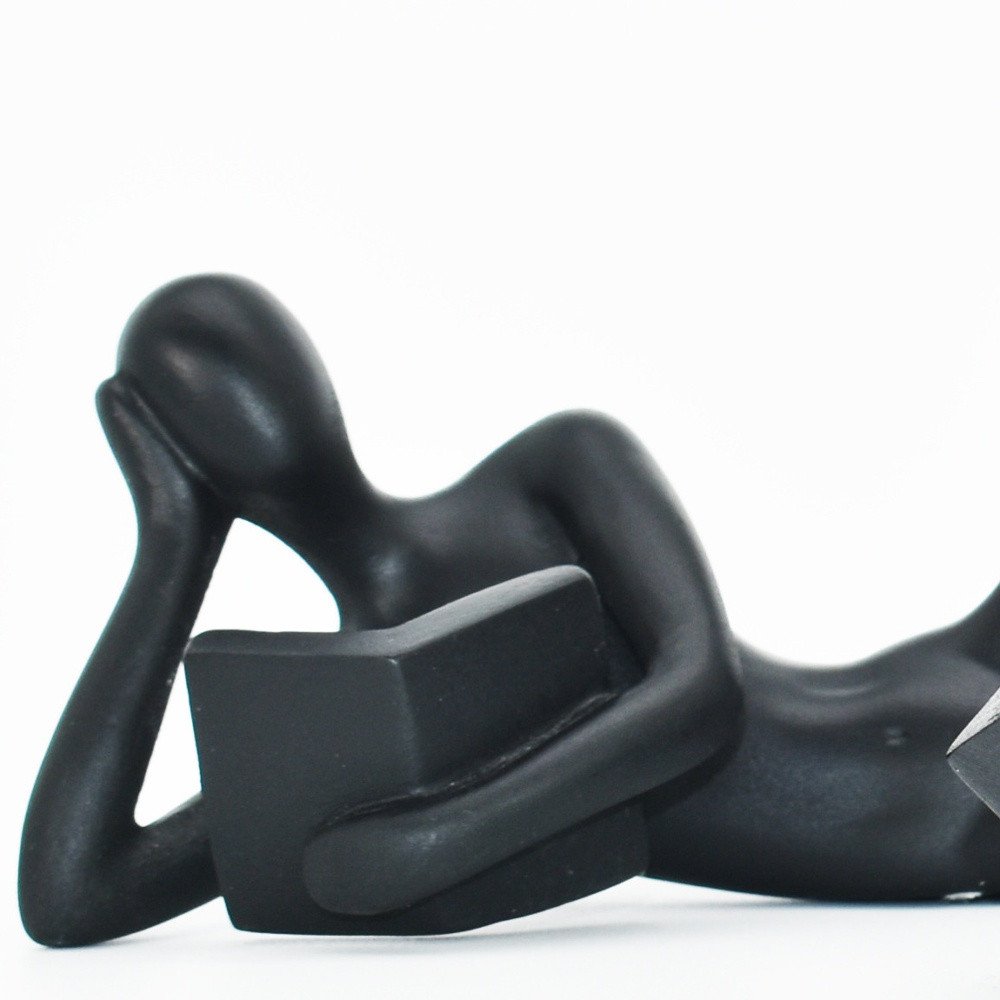 Set of Two Black Resin People Tabletop Sculpture on a white background