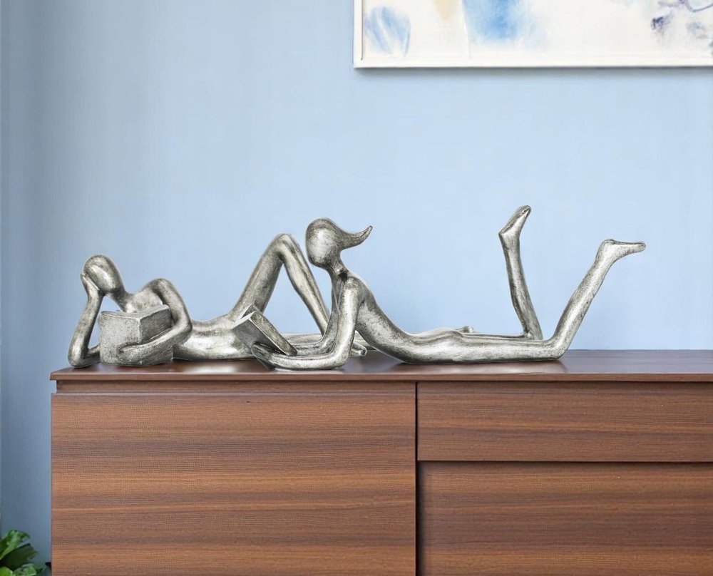 Set of Two Pewter Resin People Tabletop Sculpture in a home interior