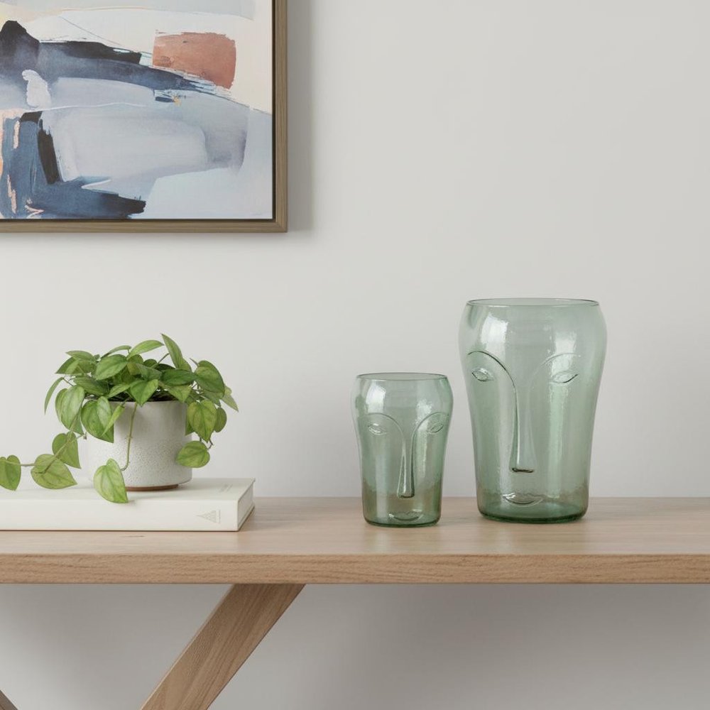 Set of Two Light Green Glass Modern Abstract Faces Table Vases on a white background