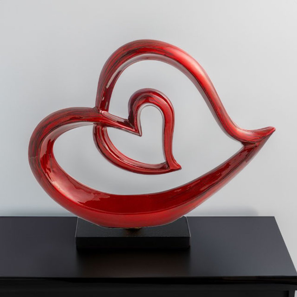 12" Red and Black Aluminum Tabletop Sculpture styled in a furnished interior with an off-white wall on a black floor.