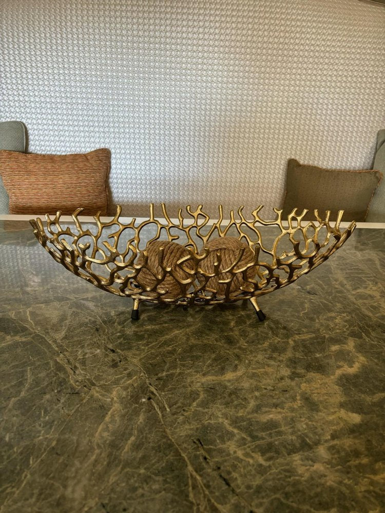 22" Silver Aluminum Faux Coral Oval Centerpiece Bowl styled in a furnished interior with a tan wall on a dark wood floor.