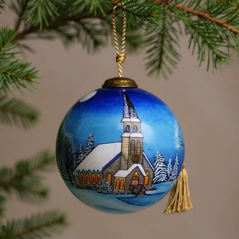 Snowy Church Christmas Hand Painted Blue And White Glass Ball Ornament in a home interior