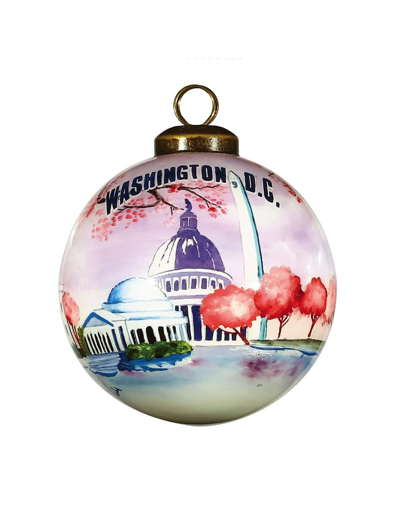 Hand-painted glass ball ornament featuring Washington D.C. landmarks in pink, purple, and blue with a gold hanger.