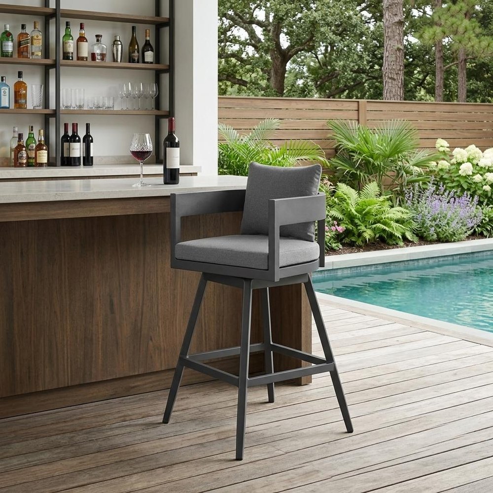 34" Dark Gray Metal Swivel Low back Outdoor Counter Height Bar chair with Footrest shown outdoors on a patio with greenery in charcoal metal.