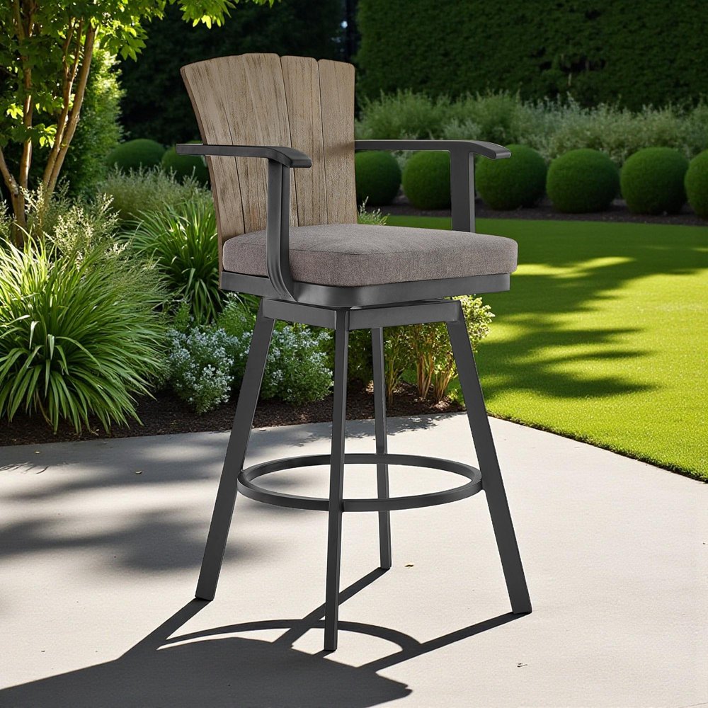 40" Charcoal Metal Swivel Outdoor Counter Height Bar chair with Footrest shown outdoors on a tiled patio with greenery.