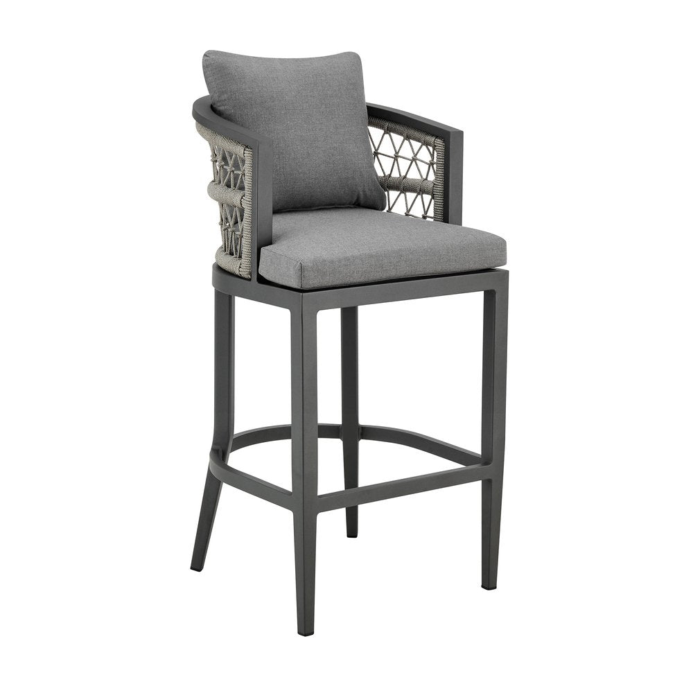 Gray metal outdoor bar height chair with gray upholstered seat and back, woven armrests, and footrest on a white background.