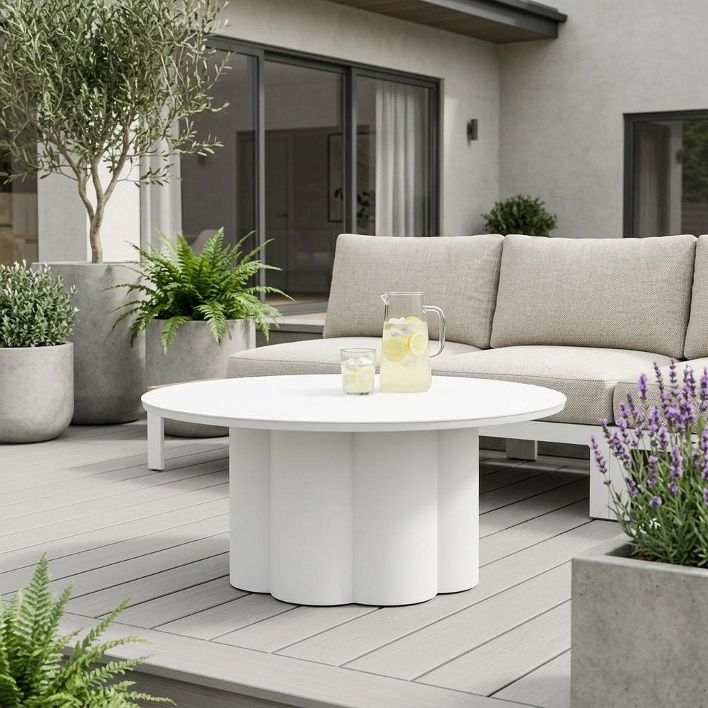 34" White Rounded Aluminum Outdoor Coffee Table shown outdoors on a tiled patio.