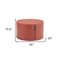 A terra cotta rounded aluminum outdoor coffee table, 29 inches wide and 15.9 inches high, with stitched detailing.