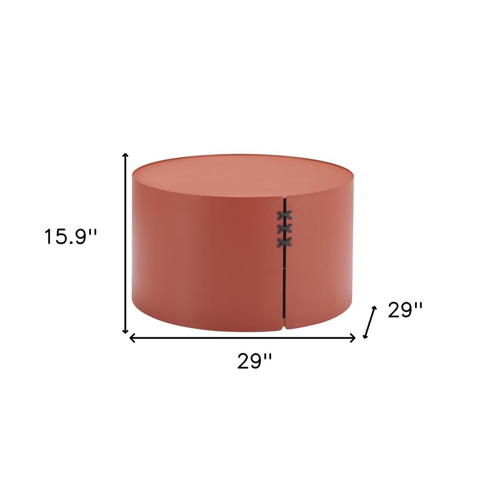 A terra cotta rounded aluminum outdoor coffee table, 29 inches wide and 15.9 inches high, with stitched detailing.