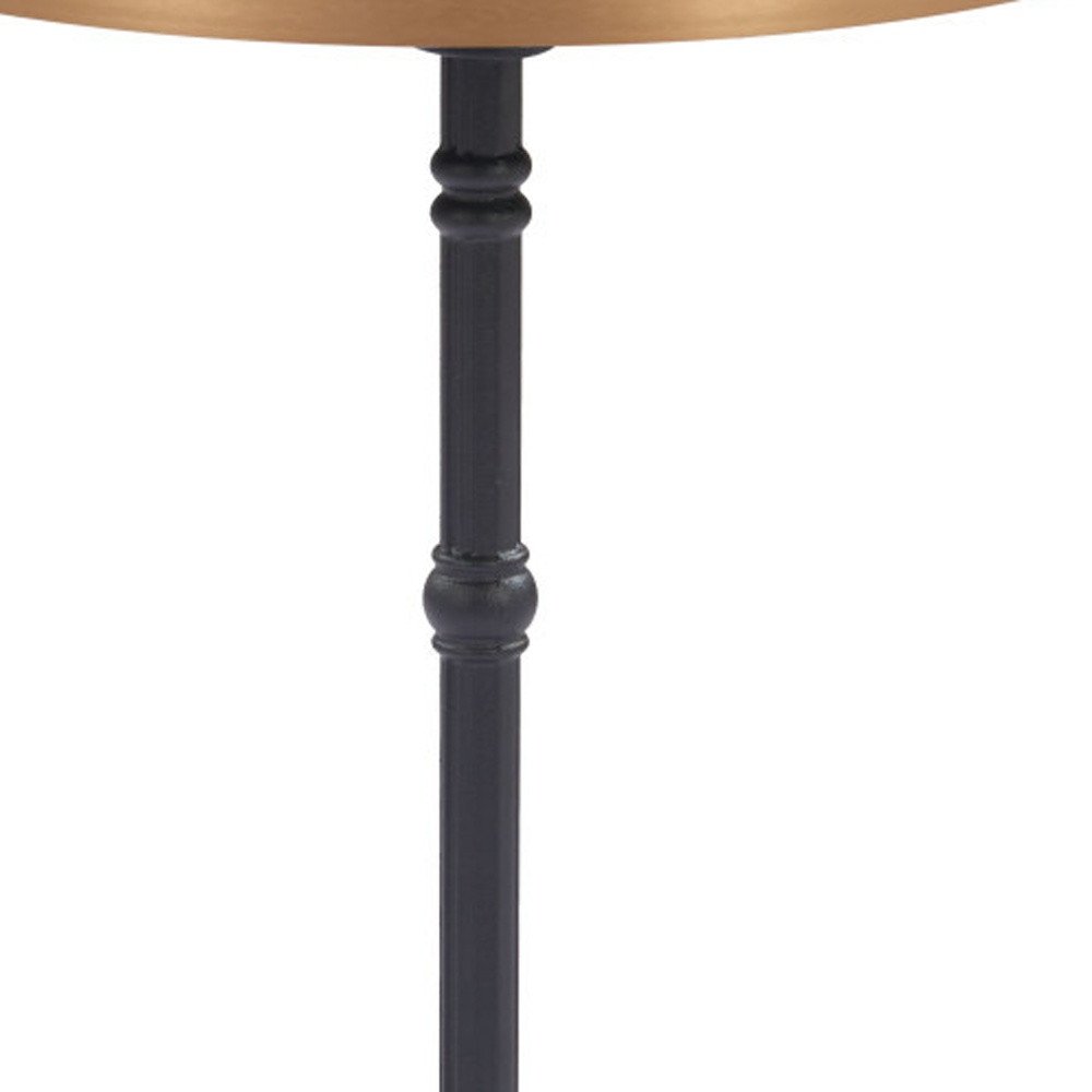 Close-up of a black metal pedestal table leg with decorative rings, supporting a round gold tabletop against a white background.