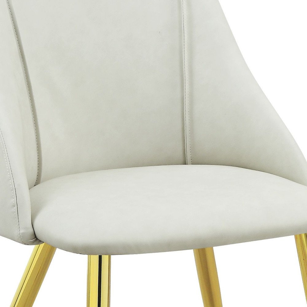 Set of Two White and Gold Upholstered Faux Leather And Metal Dining Side Chairs on a white background