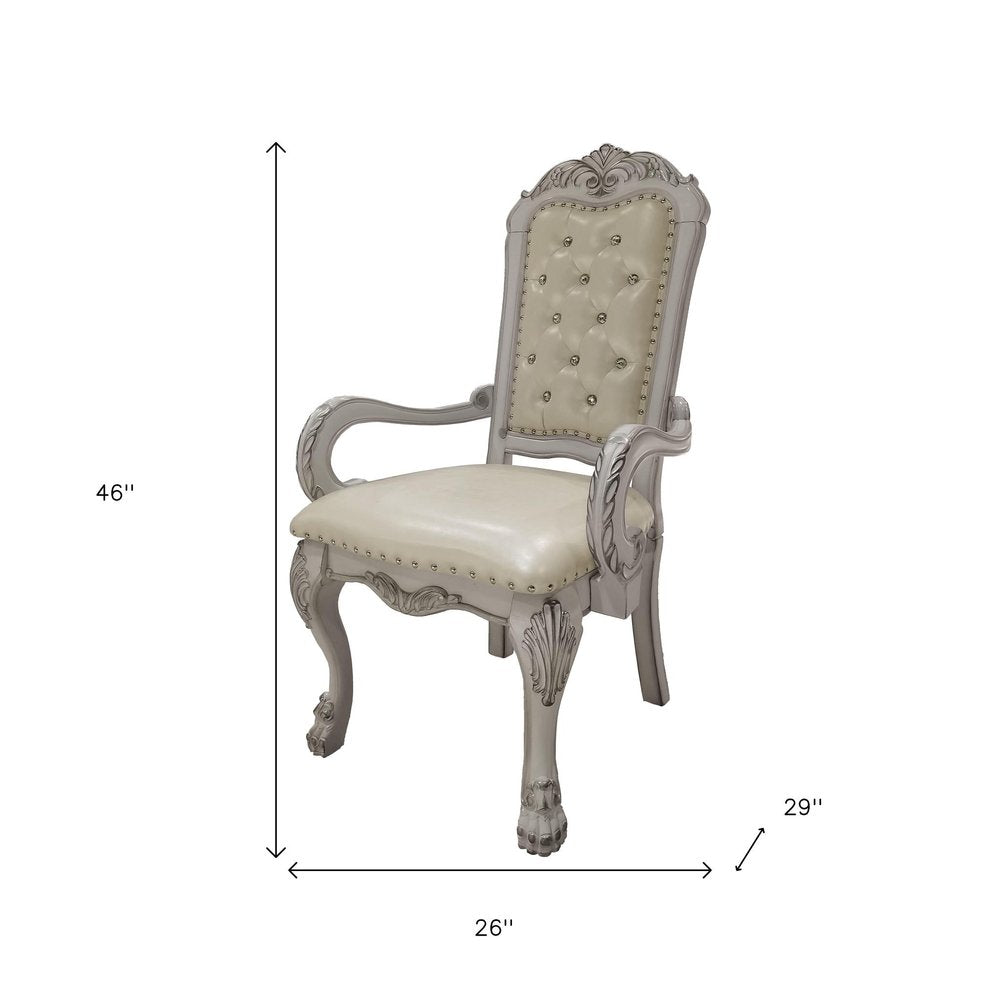 Set of Two Tufted White Upholstered Faux Leather And Wood Dining Arm Chairs on a white background