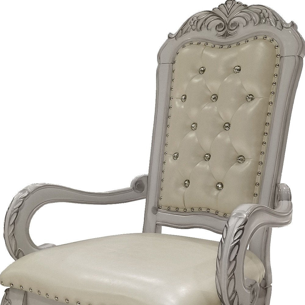 Set of Two Tufted White Upholstered Faux Leather And Wood Dining Arm Chairs on a white background
